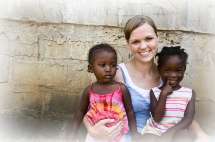 Photo of NGO volunteer with 2 girls.